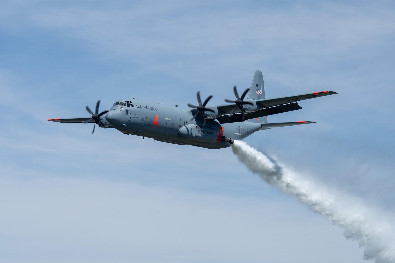 A C-130 (MAFFS 4) from California Air National Guard's 146th Airlift Wing performs a water drop April 24, 2025, during Modular Airborne Fire Fighting System, or MAFFS, Spring Training 2025, held at the Channel Islands Air National Guard Base in Port Hueneme, Calif. This part of the training was conducted in the Angeles National Forest near Green Valley, California, April 21-27, 2025.
