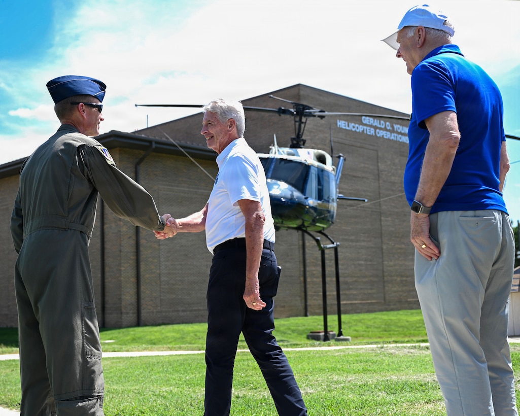 Man shaking hands with another man.