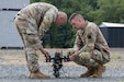 Chief Warrant Officer 2 Nathan Shea, left, and Sgt. 1st Class Brent Wehr of the Pennsylvania National Guard’s Unmanned Aircraft System Training and Innovation Facility prepare their Project R.E.D. drone for flight at U.S. Army Combat Capabilities Development Command’s Robotics and Autonomy Showcase Aug. 27, 2026, at Aberdeen Proving Ground, Maryland. (U.S. Army photo by Greg Newswanger)