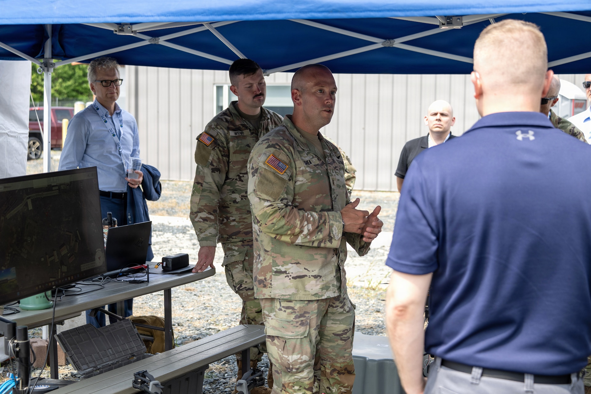 Chief Warrant Officer 2 Nathan Shea and Sgt. 1st Class Brent Wehr of the Pennsylvania National Guard’s Unmanned Aircraft System Training and Innovation Facility brief attendees about their Project R.E.D. drone at U.S. Army Combat Capabilities Development Command’s Robotics and Autonomy Showcase Aug. 27, 2026, at Aberdeen Proving Ground, Maryland. (U.S. Army photo by Greg Newswanger)