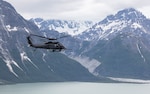 An Alaska Air National Guard HH-60W Jolly Green II, assigned to the 210th Rescue Squadron, 176th Wing, flies over Southcentral Alaska during a training mission July 8, 2026. Crew of 210th Rescue Squadron and pararescuemen of 212th Rescue Squadron rescued four occupants of a Cessna 180 after an Aug. 30, 2026, crash at Montague Island. Photo by Alejandro Pena.