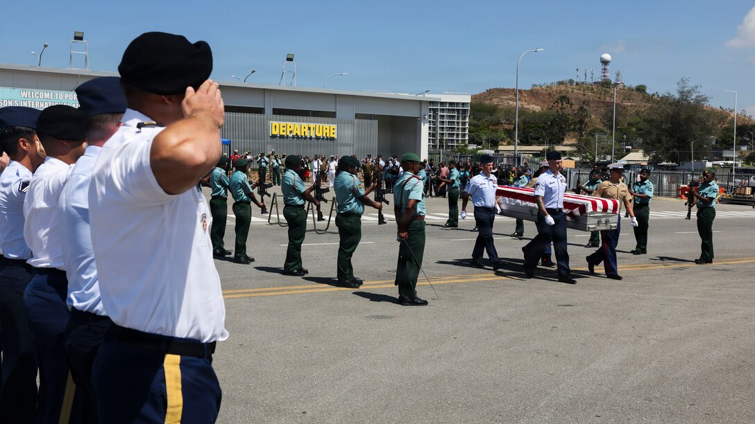 Service members assigned to the Defense POW/MIA Accounting Agency and the Papua New Guinea Defense Force present arms during the 26-2PG repatriation ceremony