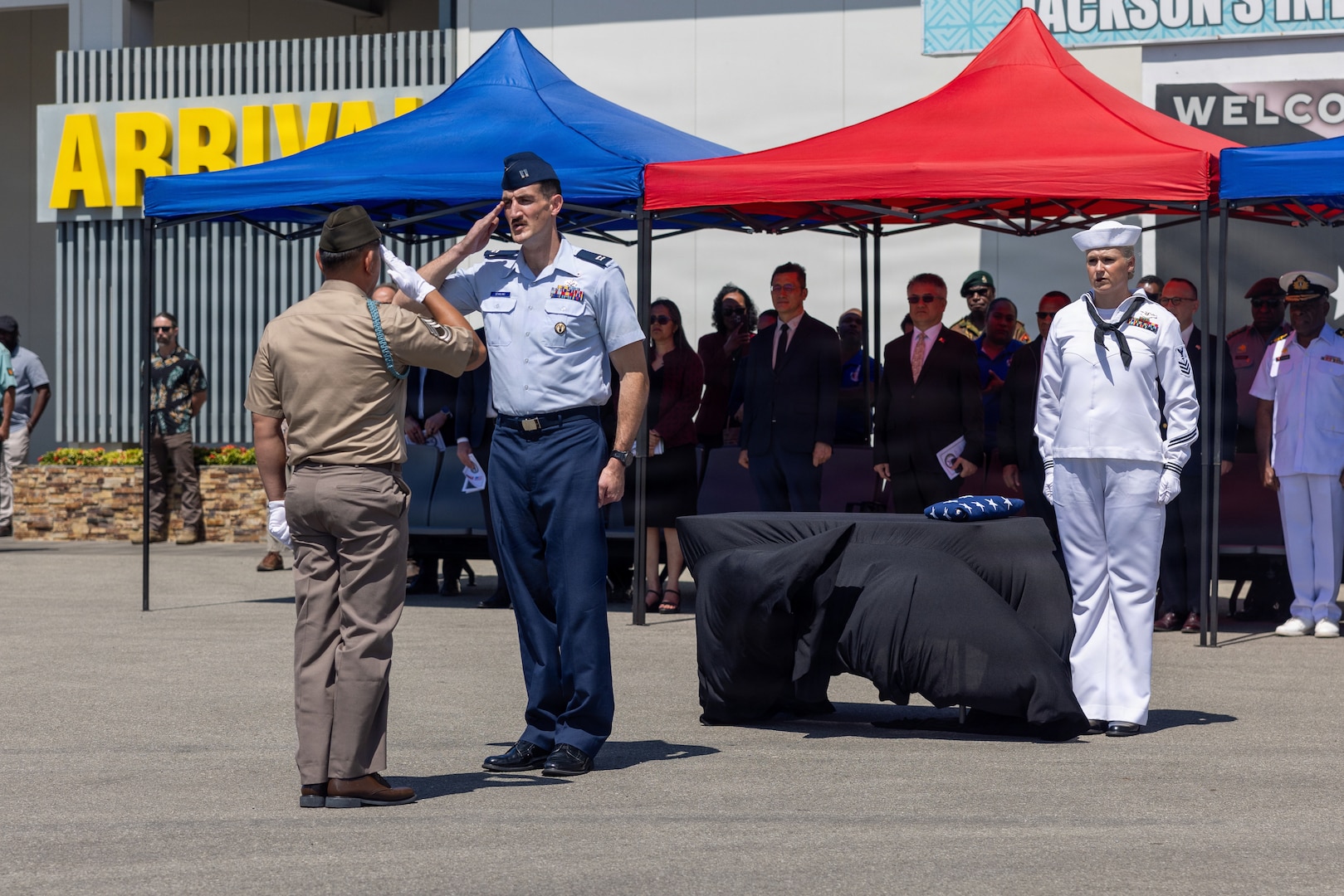 U.S. Army Sgt. 1st Class Ryan Wright, Defense POW/MIA Accounting Agency team sergeant (left), renders salute to U.S. Air Force Capt. Malachi Sparling, DPAA mission commander (middle), during the 26-2PG repatriation ceremony