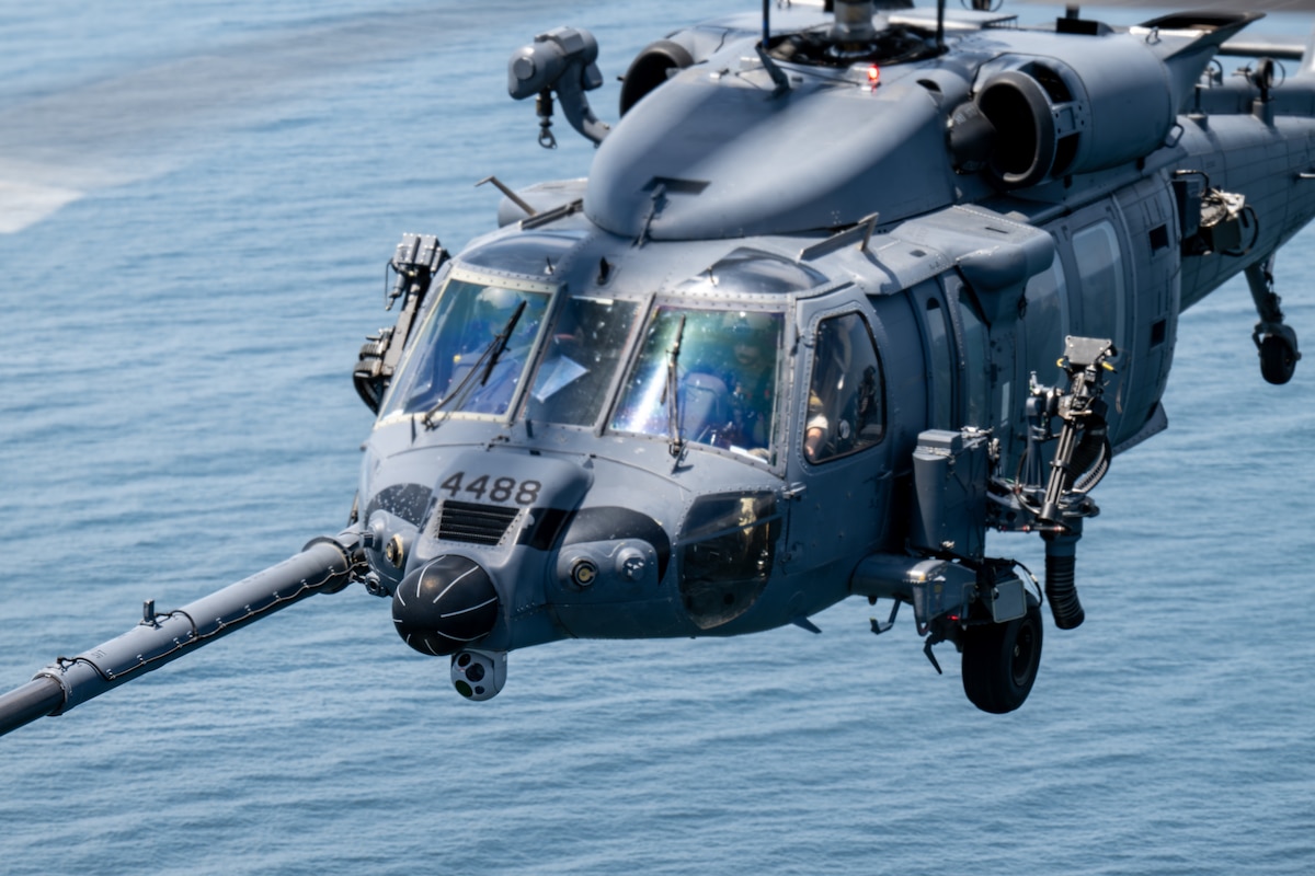 Helicopter flies over the sea.