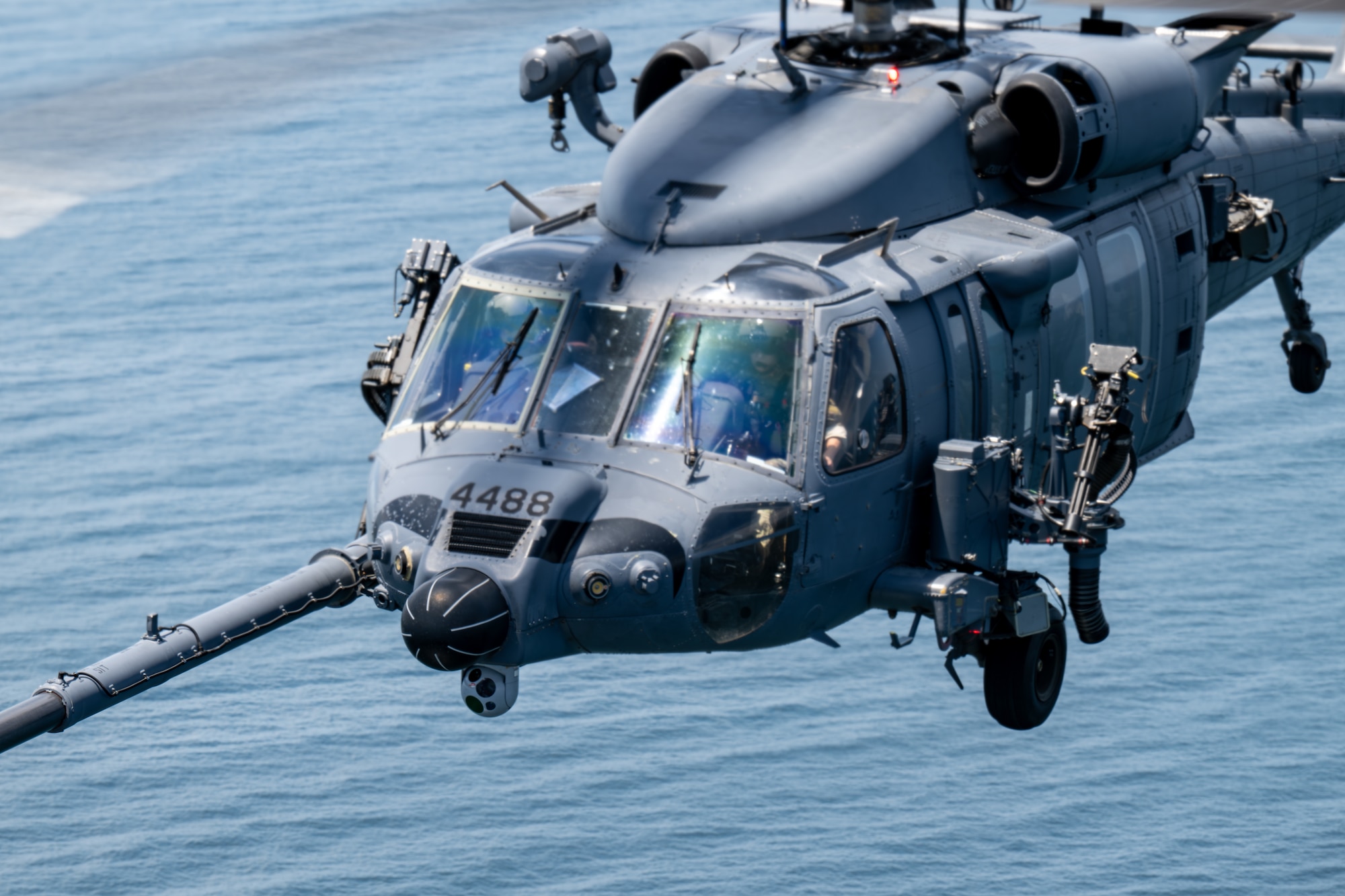 Helicopter flies over the sea.