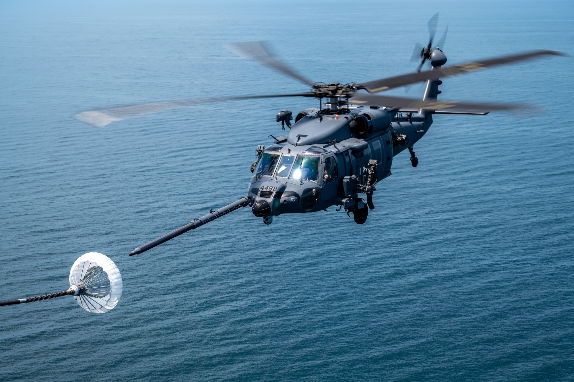 Helicopter flies over the sun.