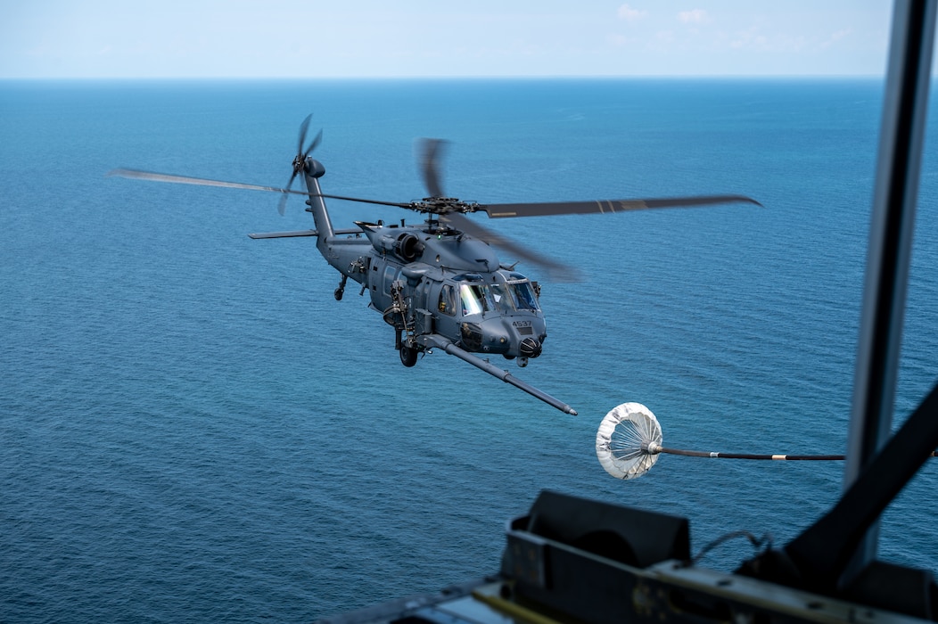 Helicopter flies over the sea.