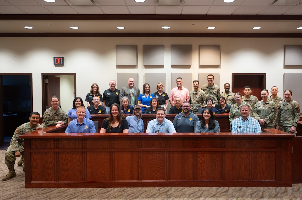 The 2025-2026 class of honorary commanders pose for a group photo with Wing Staff Agencies personnel after participating in a mock trial at Goodfellow Air Force Base, Texas, Aug. 28, 2026. The Honorary Commander Program gives community members insight on the importance of the 17th Training Wing, the Air Force mission and the Department of War through direct interactions with military commanders and their units. (U.S. Air Force photo by Senior Airman Brian Lummus)