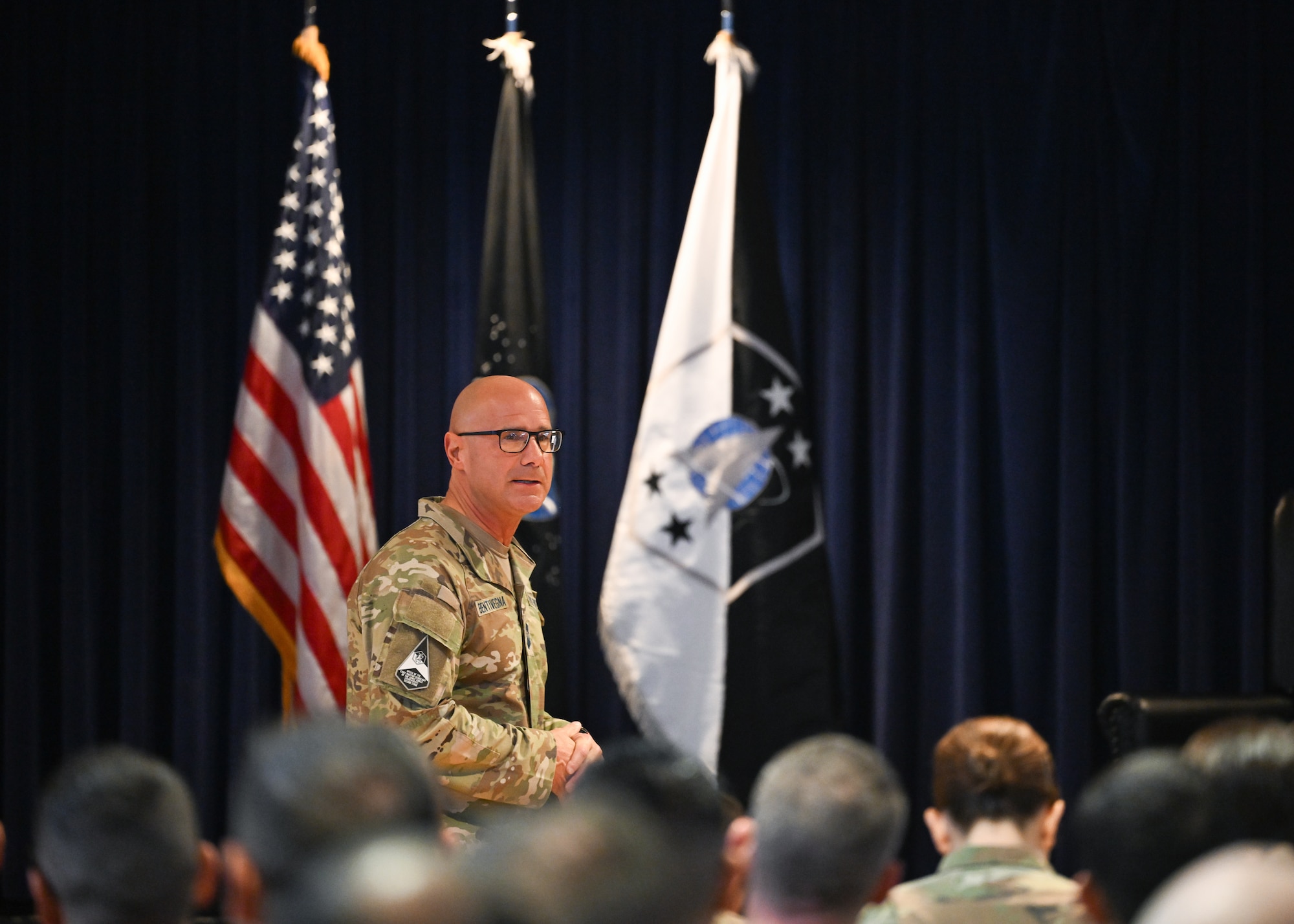 Chief Master Sgt. Bentivegna addresses an audience while in front of them.