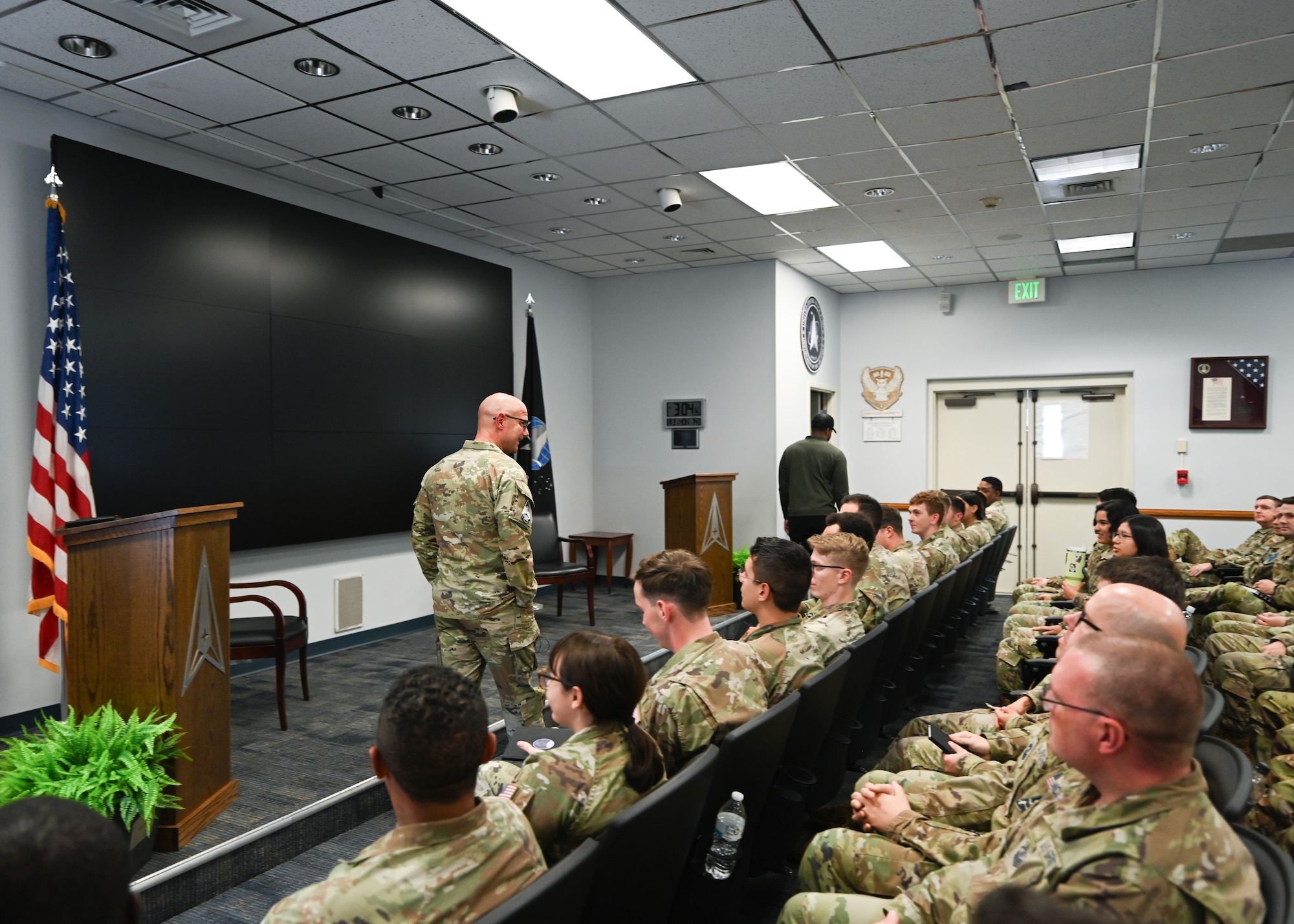 Chief Master Sgt. Bentivegna walks in front of the audience as he addresses them.