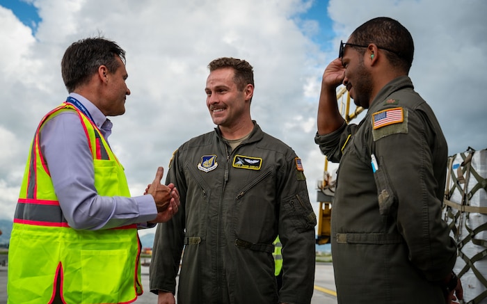 From left, U.S. Embassy Nepal Chargé d’Affaires Scott Urbom speaks with U.S. Air Force Capt. Jacob Carley and U.S. Air Force Maj. Jay Lambert, both 36th Airlift Squadron pilots, at Tribhuvan International Airport, Nepal, Sept. 2, 2026, following the delivery of life-saving supplies.
