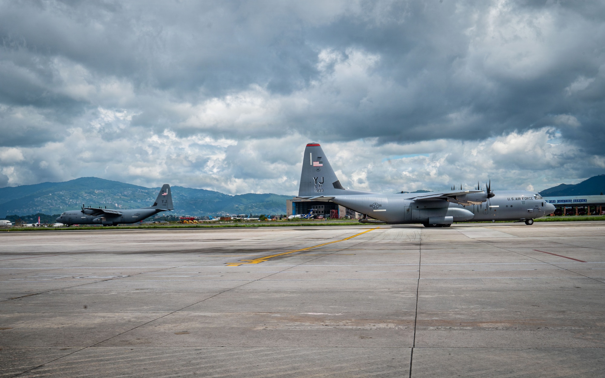 One U.S. Air Force C-130J Super Hercules, assigned to the 36th Airlift Squadron, Yokota Air Base, Japan, arrives on the flight line, as the other departs Tribhuvan International Airport, Nepal, Sept. 2, 2026, after delivering life-saving aid and supplies.