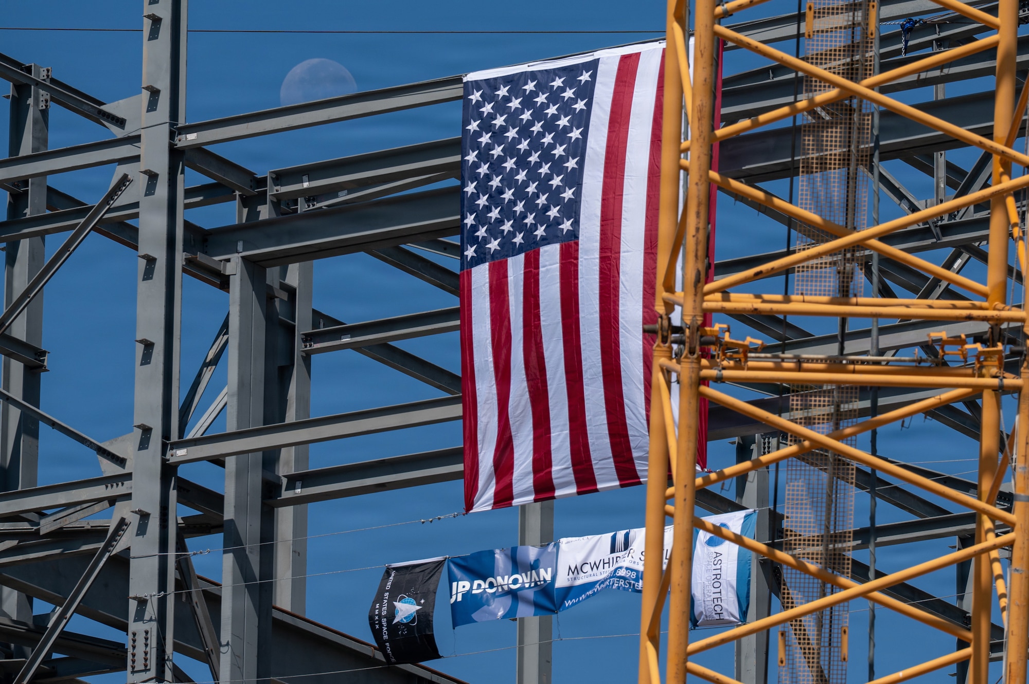 The flags dangle on a construction site.