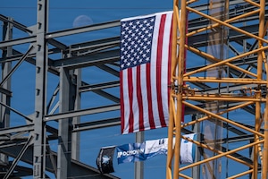 The flags dangle on a construction site.