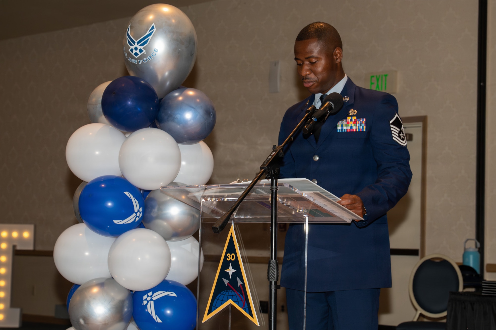 A person stands behind a podium and speaks