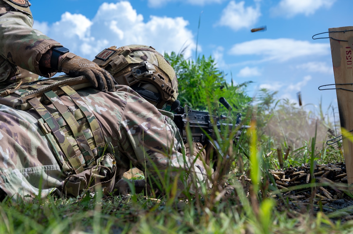 U.S. Air Force Senior Airman Dalton Smith, 35th Security Forces Squadron (SFS) military working dog handler, fires an M249 squad automatic weapon during heavy weapons training at Misawa Air Base, Japan, Aug. 28, 2026. Heavy weapons training ensures Defenders across specialized roles maintain the skills necessary to operate beyond their primary duties, increasing 35th SFS flexibility during any contingency operations in the Pacific Theater. (U.S. Air Force photo by Airman 1st Class Angelica Winther)