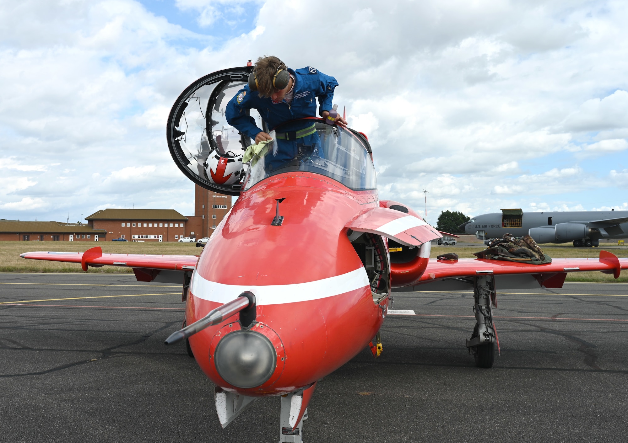 A member of the Royal Air Force Aerobatic Team’s travelling support crew, “Circus,” cleans the windshield of a Hawk T1 aircraft after the Red Arrows returned to RAF Mildenhall, England, Aug. 28, 2026. The Red Arrows performed their famous aerial demonstrations at airshows throughout the UK. (U.S. Air Force photo by Karen Abeyasekere)