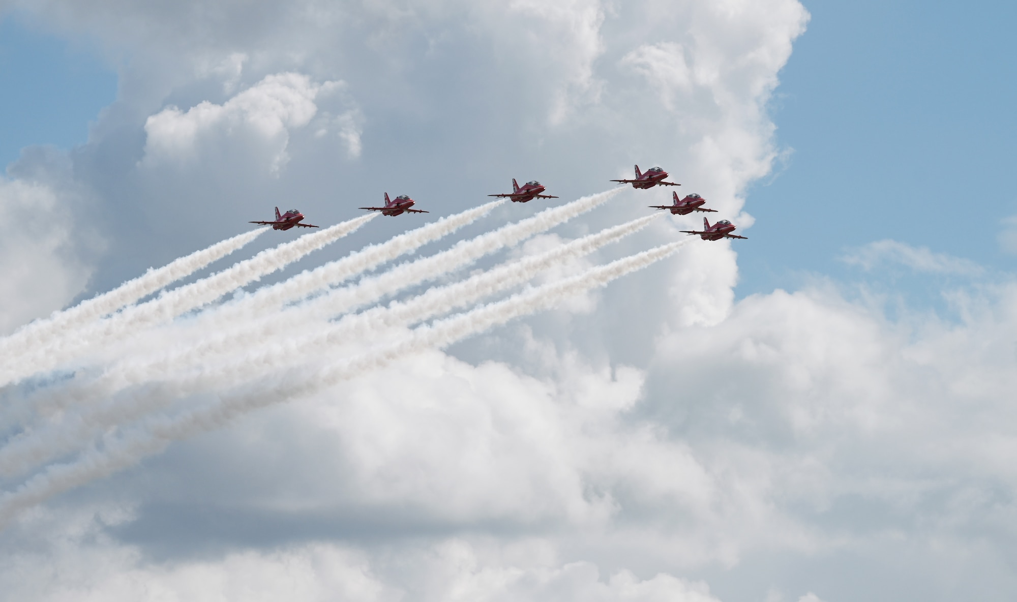The Royal Air Force Aerobatic Team, the Red Arrows, perform an aerial display as they prepare to land at RAF Mildenhall, England, Aug. 28, 2026. The Red Arrows are based at RAF Waddington in Lincolnshire and are one of the world’s premier aerobatic display teams. (U.S. Air Force photo by Karen Abeyasekere)