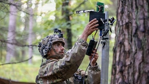 U.S. Army Cpl. Tyler Dooros, a tactical unmanned aircraft systems operator with 3rd Battalion, 504th Parachute Infantry Regiment, 173rd Mobile Brigade Combat Team (Airborne), trains to counter unauthorized drones during exercise Saber Junction 26 at Joint Multinational Readiness Center's Hohenfels Training Area, Germany, Aug. 29, 2026. The ground control system utilized disables drones by jamming their navigation and control channels. During Saber Junction 26, the U.S. Army is implementing its Continuous Transformation initiative, utilizing new technologies and systems designed to enhance its warfighting readiness and ability to respond to crisis or conflict. (U.S. Army Photo by SGT Marc Morgenstern)