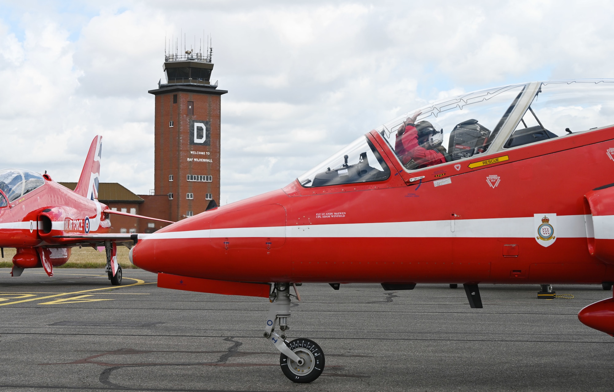 A pilot with the Royal Air Force Aerobatic Team, the Red Arrows, gives a quick wave to the travelling support crew, “Circus,” as a signal that all is good before taking off at RAF Mildenhall, England, Aug. 28, 2026. Team Mildenhall provided a wide range of support to the team during their flying visit as they performed at air shows around the UK. (U.S. Air Force photo by Karen Abeyasekere)