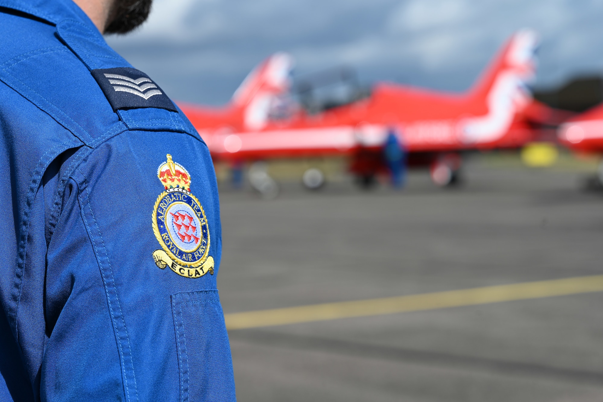 A member of the Red Arrows “Circus,” the travelling support crew of the Royal Air Force Aerobatic Team, wears the official patch of the team during a stopover at RAF Mildenhall, England, Aug. 28, 2026. The Red Arrows team stopped by RAF Mildenhall between performances at multiple air shows throughout the UK. (U.S. Air Force photo by Karen Abeyasekere)