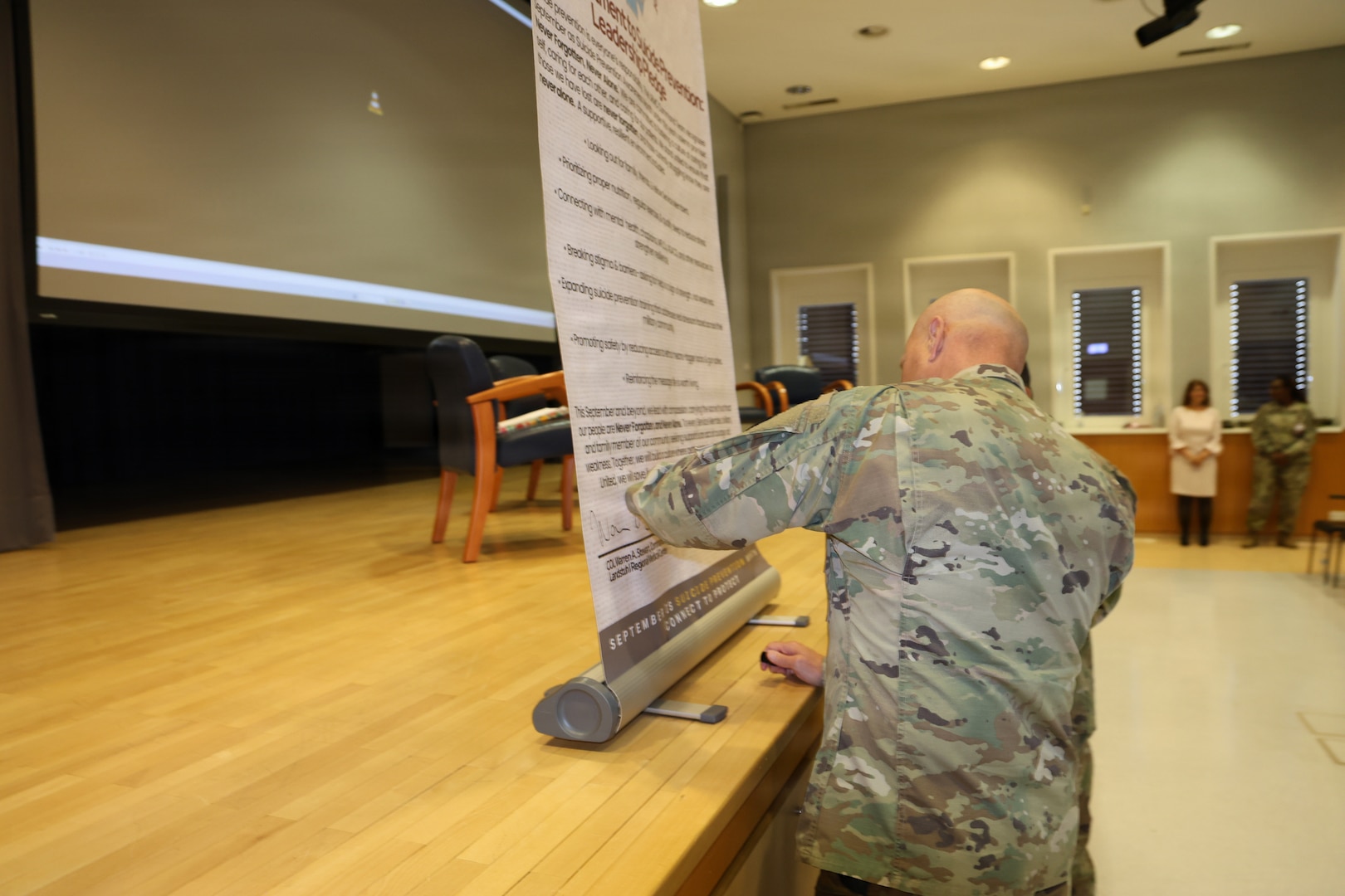 LANDSTUHL, Germany — Col Warren Stewart, commander, and Command Sgt. Maj. Jorge Oquendo, senior noncommissioned officer, Landstuhl Regional Medical Center signed the Our Commitment to suicide Prevention Pledge, at the annual Suicide Prevention and Awareness month Luncheon with a dedicated observance sept 1 in the Heaton Auditorium. The ceremony opened with a video showing real text and a video of the command team talking about importance of suicide awareness and a fireside chat with providers.