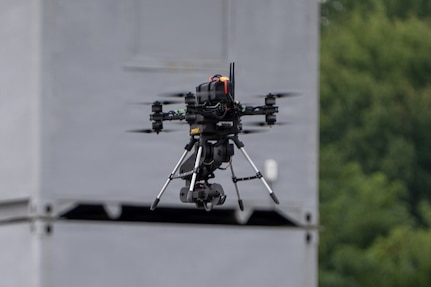 The Pennsylvania National Guard Unmanned Aircraft System Training and Innovation Facility's Project R.E.D. drone, with its mechanical arm stowed, hovers over another drone during U.S. Army Combat Capabilities Development Command’s Robotics and Autonomy Showcase Aug. 27, 2026, at Aberdeen Proving Ground, Maryland.