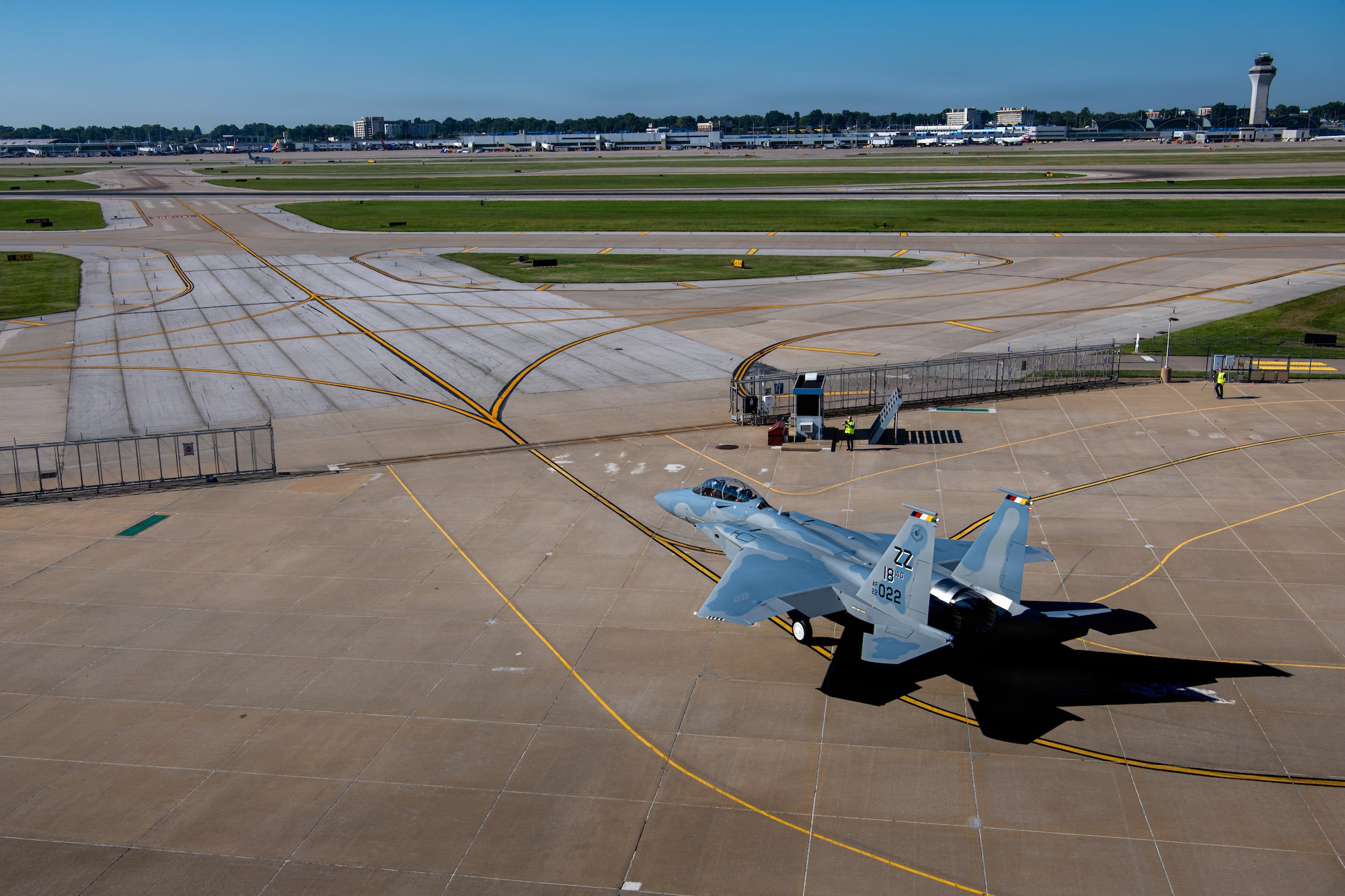 top down view of a jet aircraft as it taxis to a runway