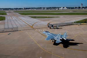 top down view of a jet aircraft as it taxis to a runway