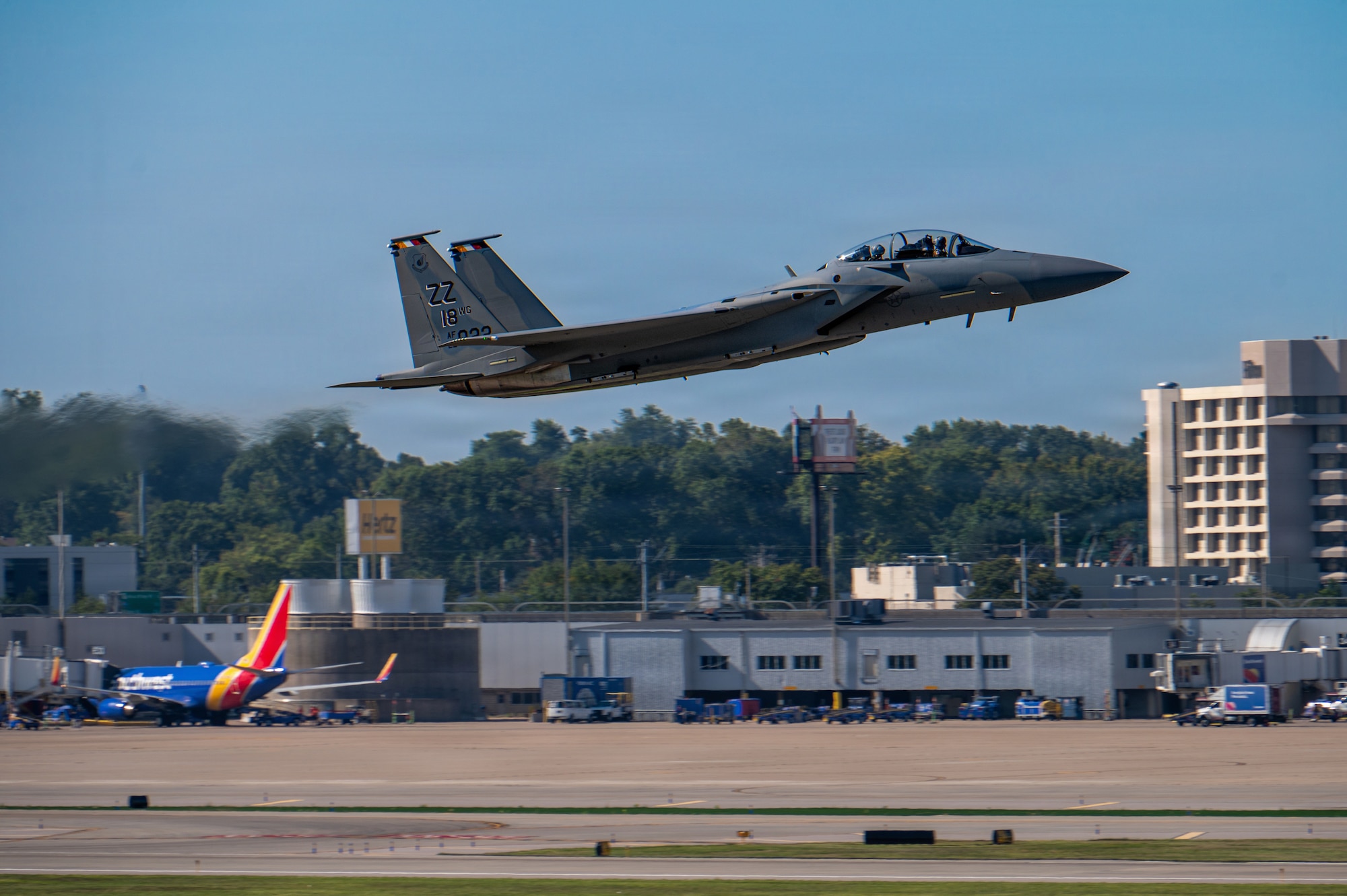 side view of a fighter jet taking off from a runway