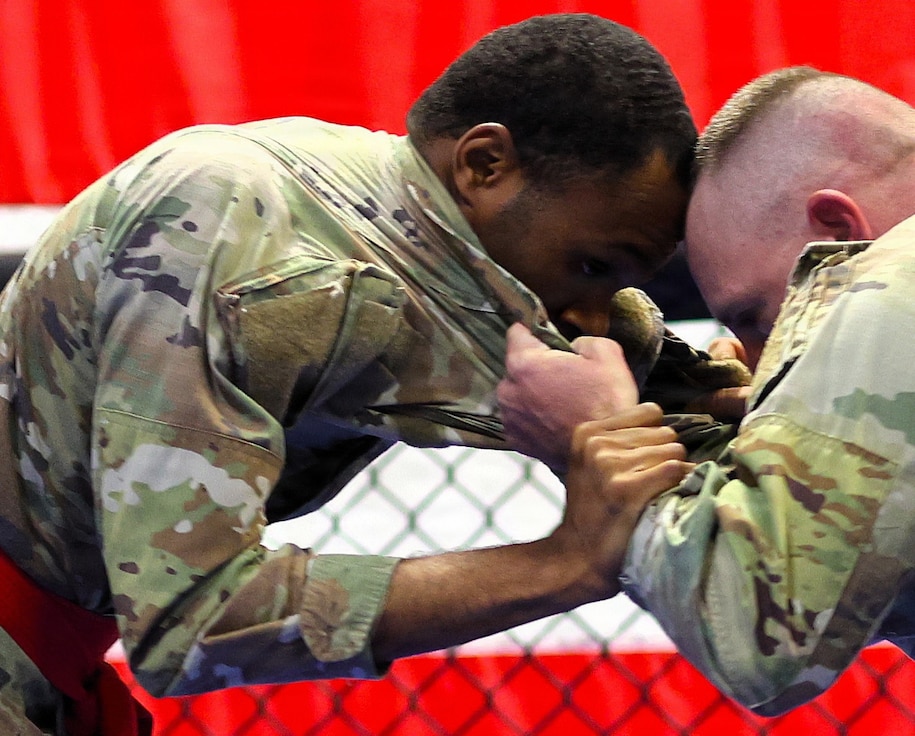 Spc. Saquan Bufford (with the red belt) fights Sgt. 1st Class Nicholas Beal in the lightweight championship.