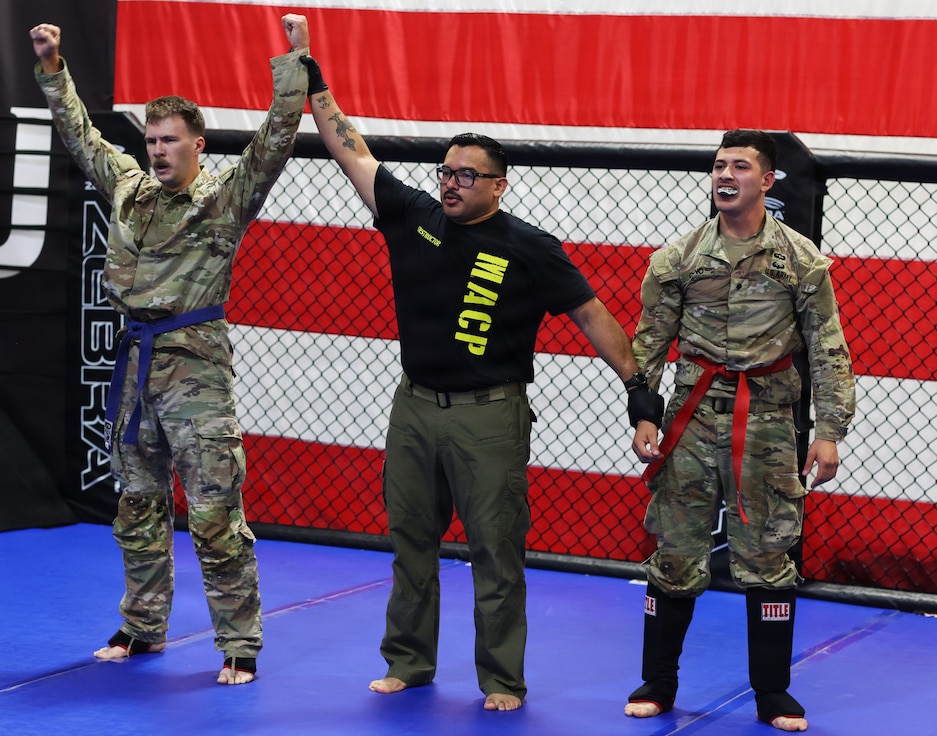 Spc. William Eyre raises both hands in victory after defeating Spc. Manuel Cano.