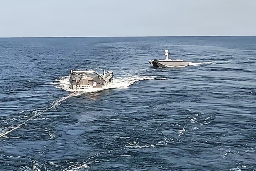 A refueling system is deployed in the water toward an unmanned vessel.