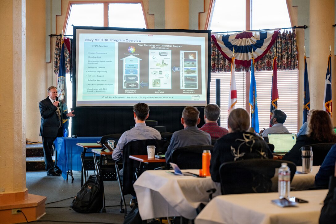 Attendees of the Digital Transformation in Metrology Workshop listen to a brief from Robert E. Fritzsche, metrology and calibration chief engineer at Naval Surface Warfare Center (NSWC) Corona Division, at the Lake Norconian Conference Center in Norco, Calif., May 18, 2026. The landmark international workshop brought together over 80 experts from the Department of War, other U.S. federal agencies, industry, and partner nations to forge a path towards a shared, secure, and standardized international digital infrastructure for measurement data.