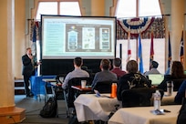 Attendees of the Digital Transformation in Metrology Workshop listen to a brief from Robert E. Fritzsche, metrology and calibration chief engineer at Naval Surface Warfare Center (NSWC) Corona Division, at the Lake Norconian Conference Center in Norco, Calif., May 18, 2026. The landmark international workshop brought together over 80 experts from the Department of War, other U.S. federal agencies, industry, and partner nations to forge a path towards a shared, secure, and standardized international digital infrastructure for measurement data.