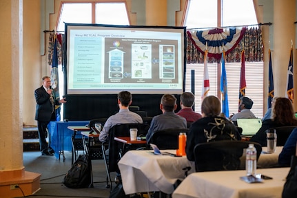 Attendees of the Digital Transformation in Metrology Workshop listen to a brief from Robert E. Fritzsche, metrology and calibration chief engineer at Naval Surface Warfare Center (NSWC) Corona Division, at the Lake Norconian Conference Center in Norco, Calif., May 18, 2026. The landmark international workshop brought together over 80 experts from the Department of War, other U.S. federal agencies, industry, and partner nations to forge a path towards a shared, secure, and standardized international digital infrastructure for measurement data.