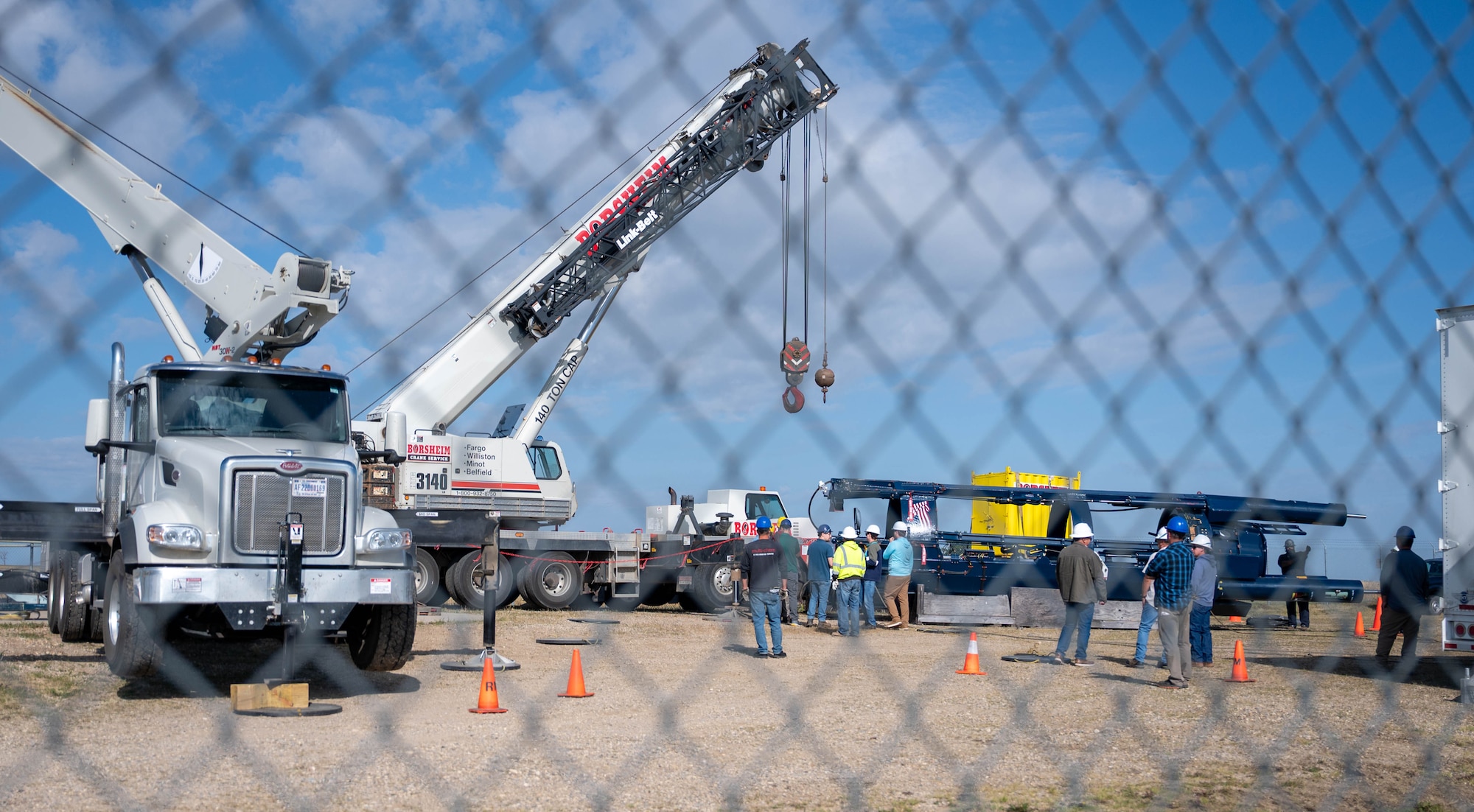 Missile maintenance technicians assigned to the 583rd Missile Maintenance Squadron prepare to lift a missile suspension system with a crane at a launch facility near Minot Air Force Base, North Dakota, Aug. 18, 2026.