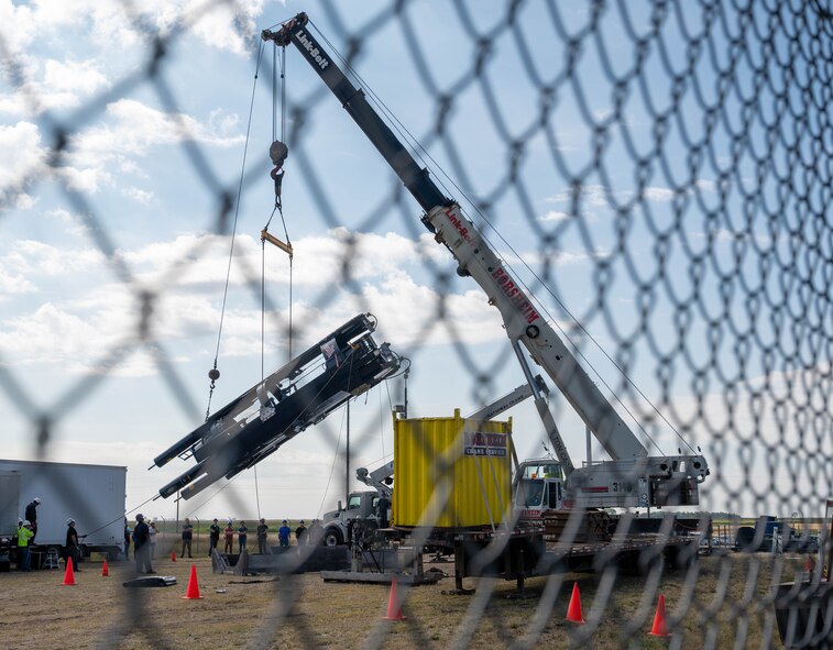 Missile maintenance technicians with the 583rd Missile Maintenance Squadron raise a newly refurbished missile suspension system at a launch facility near Minot Air Force Base, North Dakota, Aug. 18, 2026.