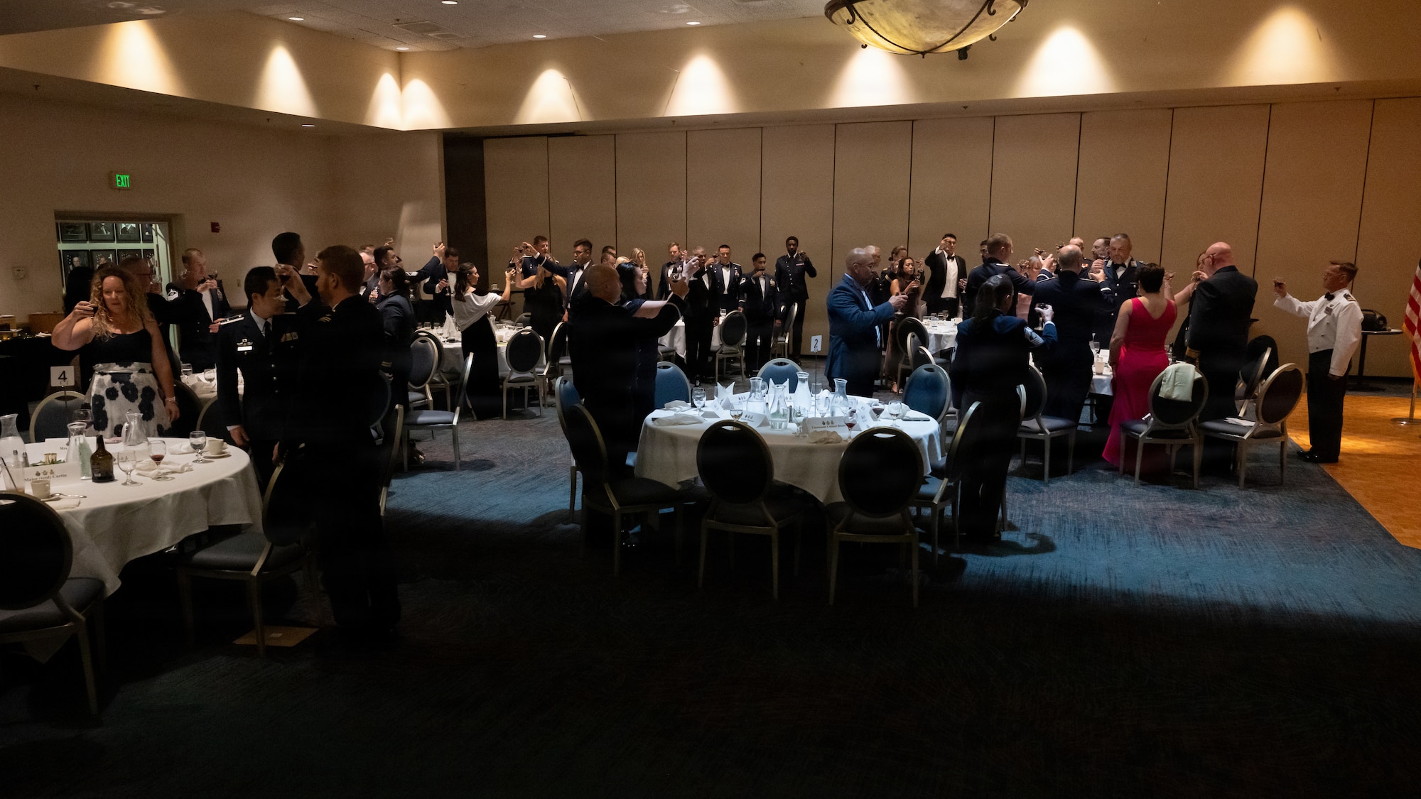 A crowd toasts the fallen.