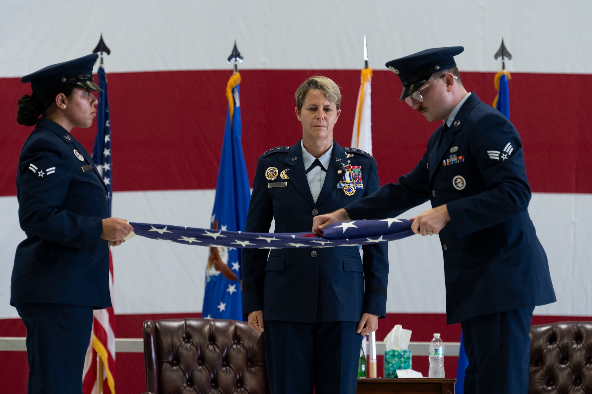 Airmen from Scott Air Force Base Honor Guard fold an American flag for Lt. Gen. Rebecca Sonkiss, Air Mobility Command deputy commander, during her retirement ceremony on Scott Air Force Base, Illinois, September 3, 2026. The folded American flag belonged to her late father, and she flew the flag to honor her father’s legacy during her last flight, where she piloted a C-17 Globemaster III at Joint Base Lindsey Graham, South Carolina. (U.S. Air Force photo by Tech. Sgt. Dalton Williams)