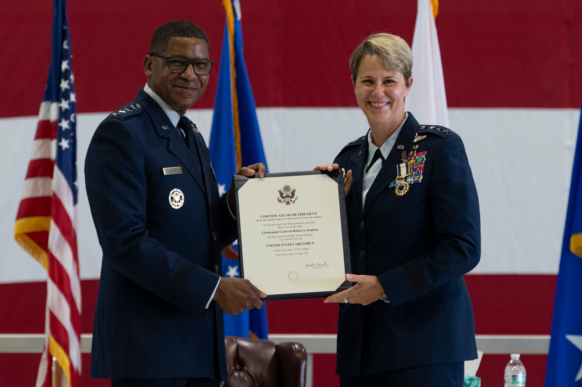 U.S. Air Force Gen. Randall Reed, commander of U.S. Transportation Command, presents a certificate to Lt. Gen. Rebecca Sonkiss, Air Mobility Command deputy commander, during her retirement ceremony on Scott Air Force Base, Illinois, September 3, 2026. Members across the mobility enterprise, family, and distinguished guests gathered to honor Sonkiss’s strategic contributions to joint warfighting readiness and her advocacy for Airmen through 32 years of distinguished military service. (U.S. Air Force photo by Tech. Sgt. Dalton Williams)