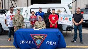 U.S. Air Force Lt. Col. Shaun Hyland-Moore, 87th Civil Engineer Squadron commander, poses with the 87th CES emergency management flight after signing the National Preparedness Month proclamation at Joint Base McGuire-Dix-Lakehurst, N.J., Sept. 3, 2026.