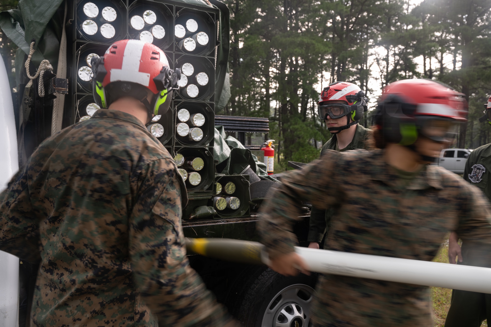 U.S. Marines assigned to Marine Light Attack Helicopter Squadron (HMLA) 773 and Marine Aviation and Logistics Squadron (MALS) 49 move high-explosive rockets during forward arming and refueling point operations at Joint Base McGuire-Dix-Lakehurst, N.J., Aug. 27, 2026.