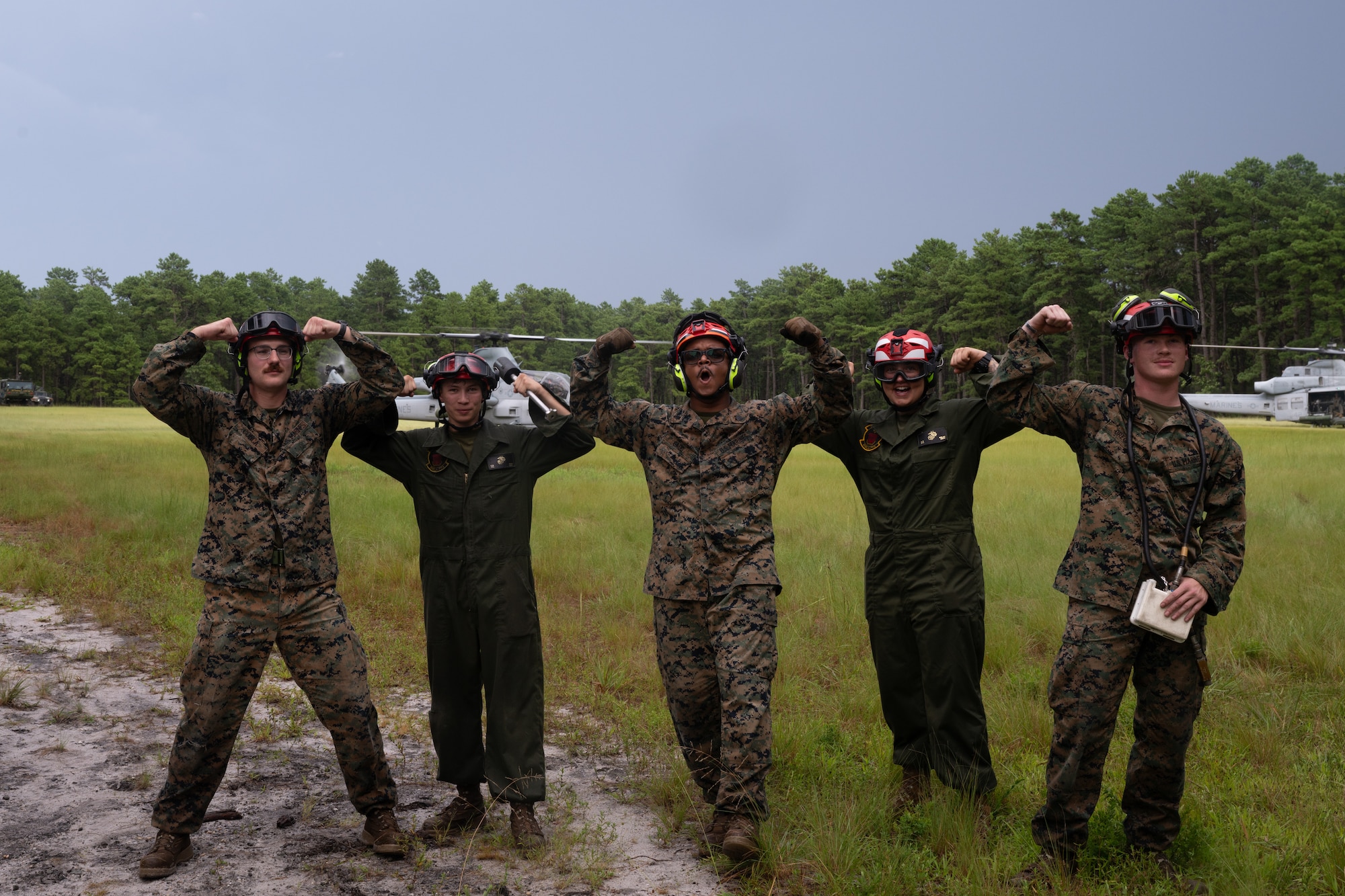 U.S. Marines with Marine Light Attack Helicopter Squadron (HMLA) 773 and Marine Aviation and Logistics Squadron (MALS) 49 pose for a group photo during a forward arming and refueling point exercise at Joint Base McGuire-Dix-Lakehurst, N.J., Aug. 27, 2026.