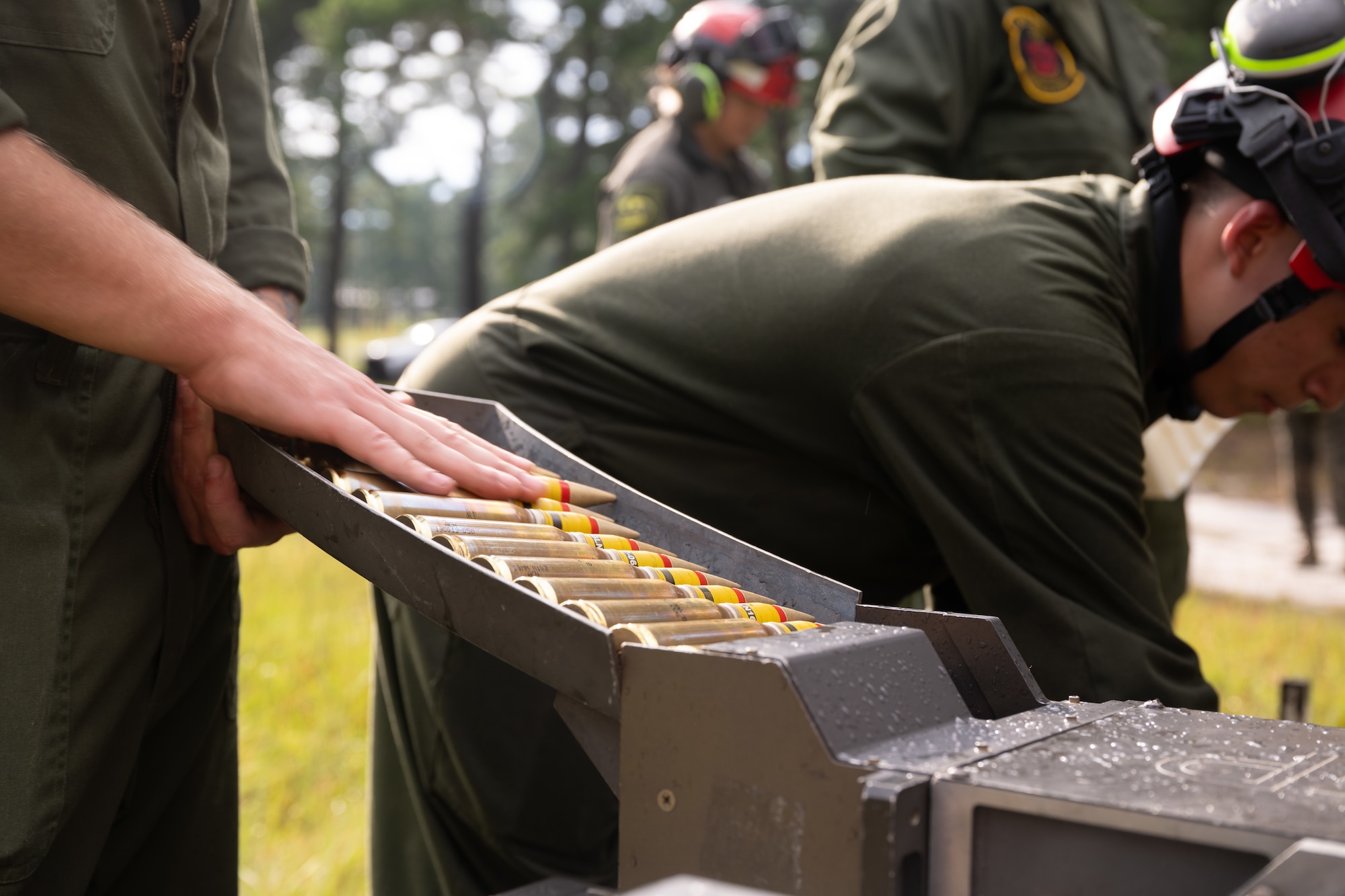 A U.S. Marine assigned to Marine Light Attack Helicopter Squadron (HMLA) 773 loads ammunition for an AH-1Z Viper helicopter during a forward arming and refueling point exercise at Joint Base McGuire-Dix-Lakehurst, N.J., Aug. 27, 2026.