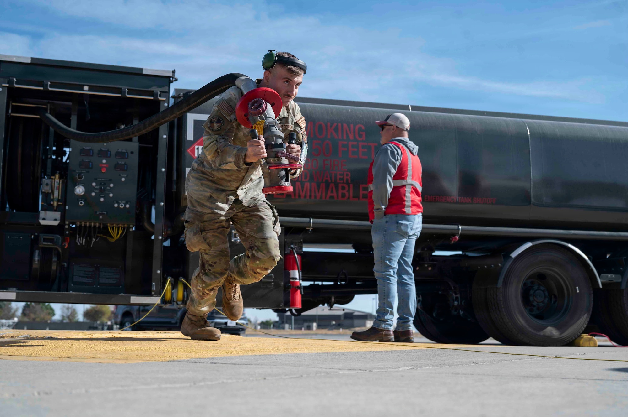 U.S. Air Force Airman Reland Brennan, 92nd Logistics Readiness Squadron fuels distribution operator, carries a fuel hose to a KC-135 Stratotanker during exercise Titan Fury 26-6 at Fairchild Air Force Base, Washington, Aug. 31, 2026.