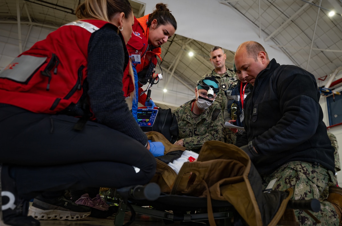 U.S. Navy Sailors assigned to Expeditionary Resuscitative Surgical System team 9 and Suðurnes Health Institution Triage Team medical personnel treat a simulated casualty during an artificial mass casualty scenario as part of exercise Northern Viking 26 at Keflavík Air Base, Iceland