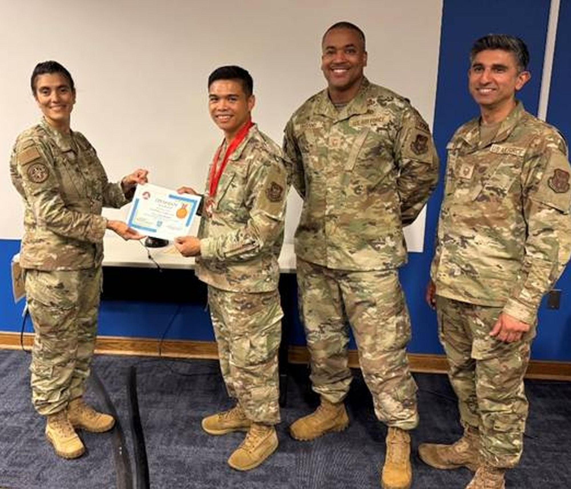 DPH director Col. Anita Edmonds presents 459th Force Support Squadron’s EVOLVE Bronze Certification to Major Miguel Santos, Senior Master Sgt. Jamie Serrano and Master Sgt. Hiba Rafiq, June 11, 2026, at Joint Base Andrews, Md. (U.S. Air Force photo by Col. Jessica Greening)