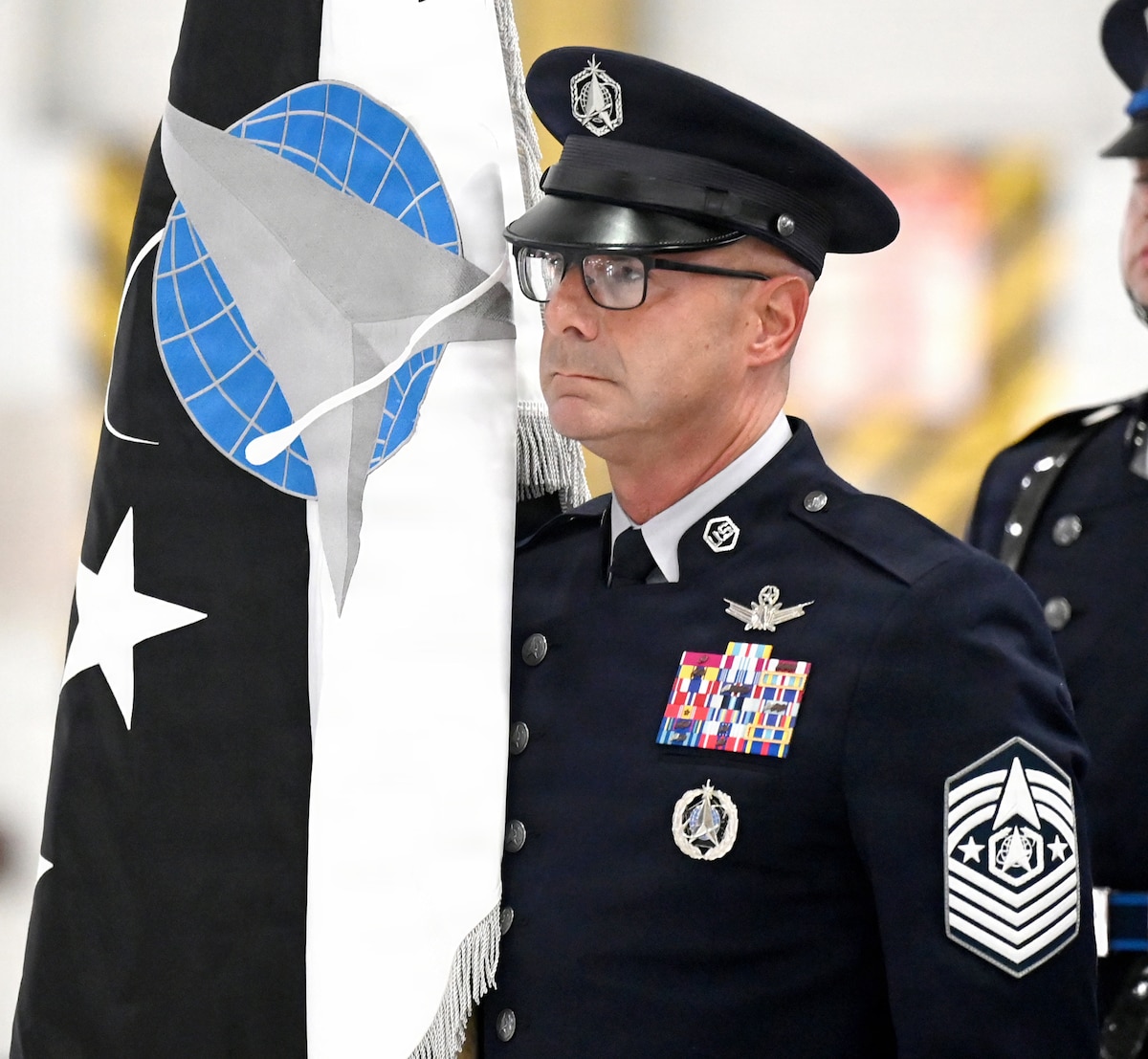 Chief Master Sergeant of the Space Force John Bentivegna prepares to deliver the ceremonial Chief of Space Operations flag to Secretary of the Air Force Troy Meink during a Change of Responsibility ceremony, Joint Base Andrews Md., Sept 3, 2026. During the ceremony, Gen. Douglas Schiess was appointed the new Chief of Space Operations. (U.S. Air Force photo by Andy Morataya)