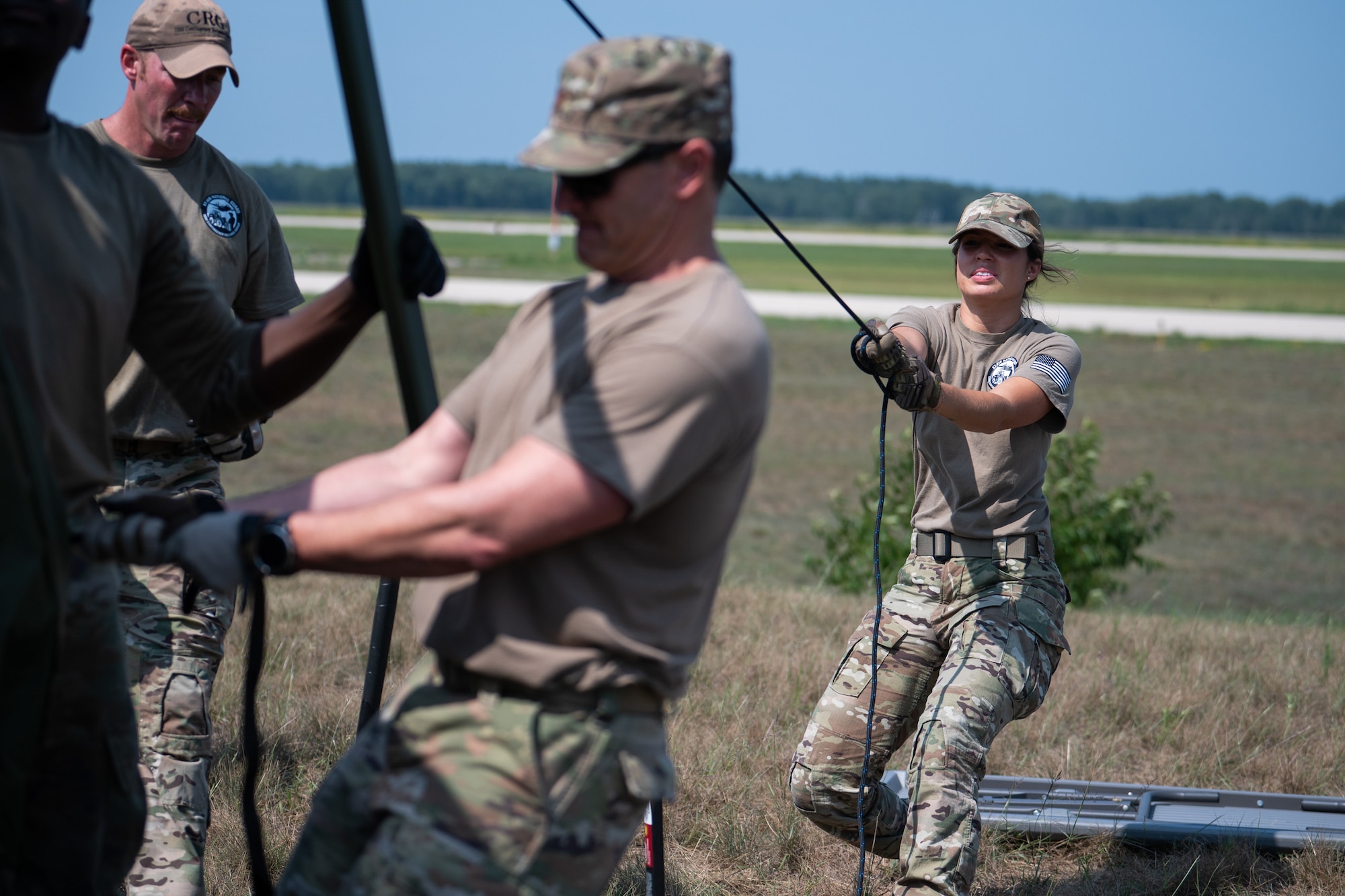 U.S. Air Force Master Sgt. Lindsey Horton, a personnelist assigned to conduct contingency operations for the Kentucky Air National Guard’s 123rd Contingency Response Group, assists with tent setup during exercise Patriot 2026 at Volk Field Combat Readiness Training Center, Wis., Aug. 20, 2026. Patriot 26, an Air National Guard-hosted exercise brings together approximately 1,000 Airmen and Soldiers from National Guard units across 35 states, along with federal, state and local agencies, to enhance domestic response readiness and interagency coordination during large-scale emergencies. (U.S. Air National Guard photo by Senior Airman Angelee Barnett)